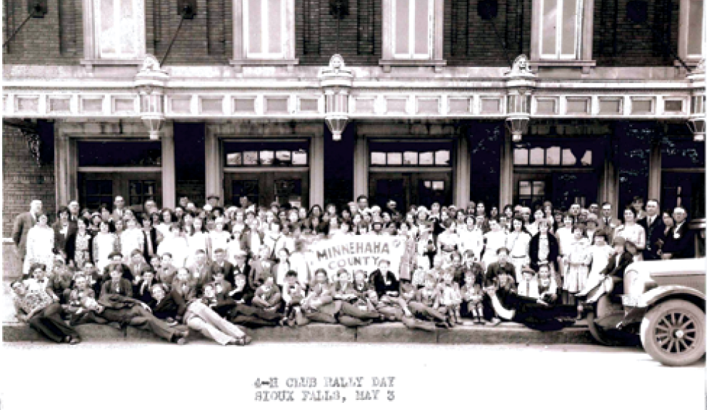 Members of the Minnehaha County 4-H club group photo in front of a building. May 3, 1930 Sioux Falls, SD