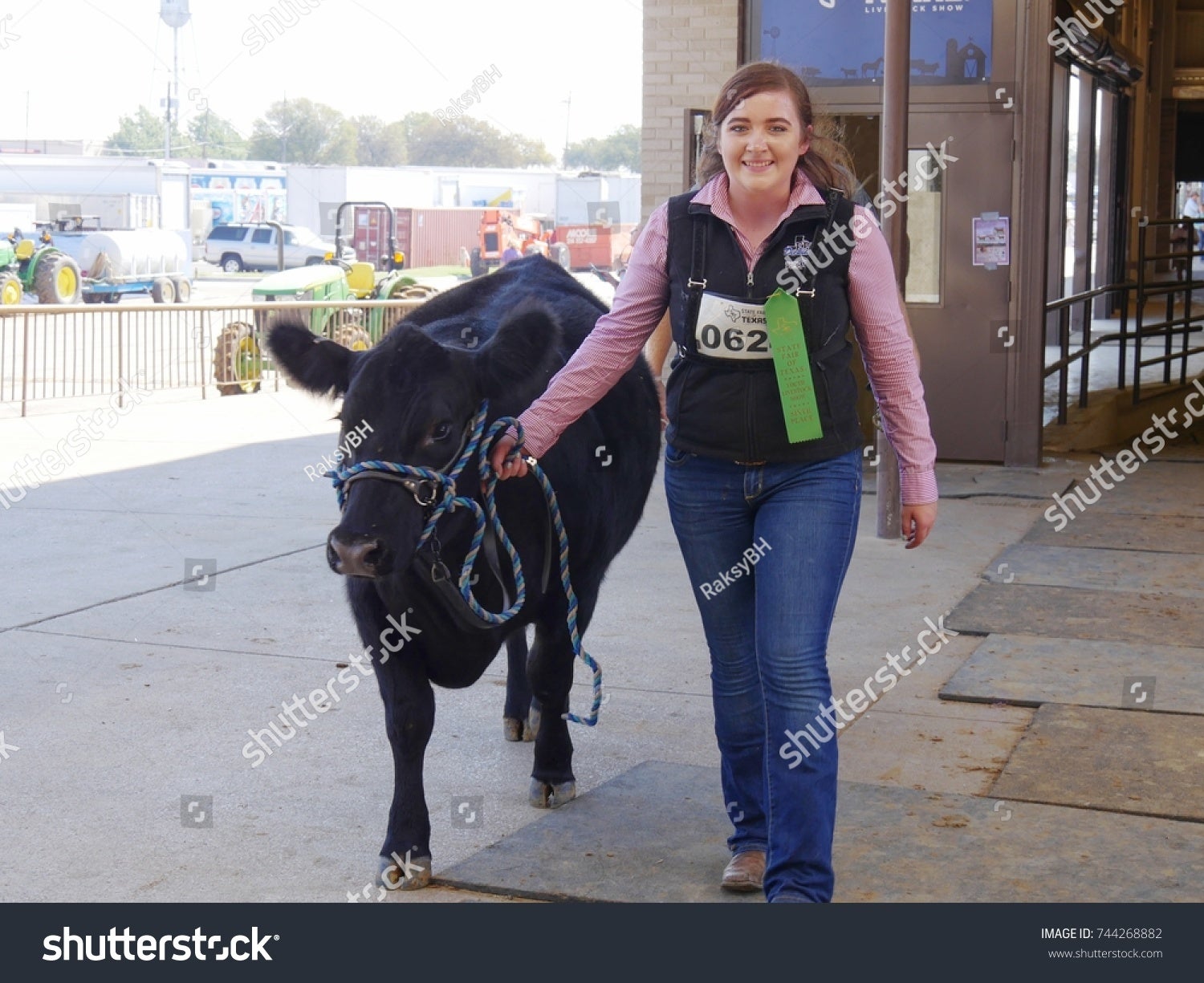 Teen girl walking her winning cow
