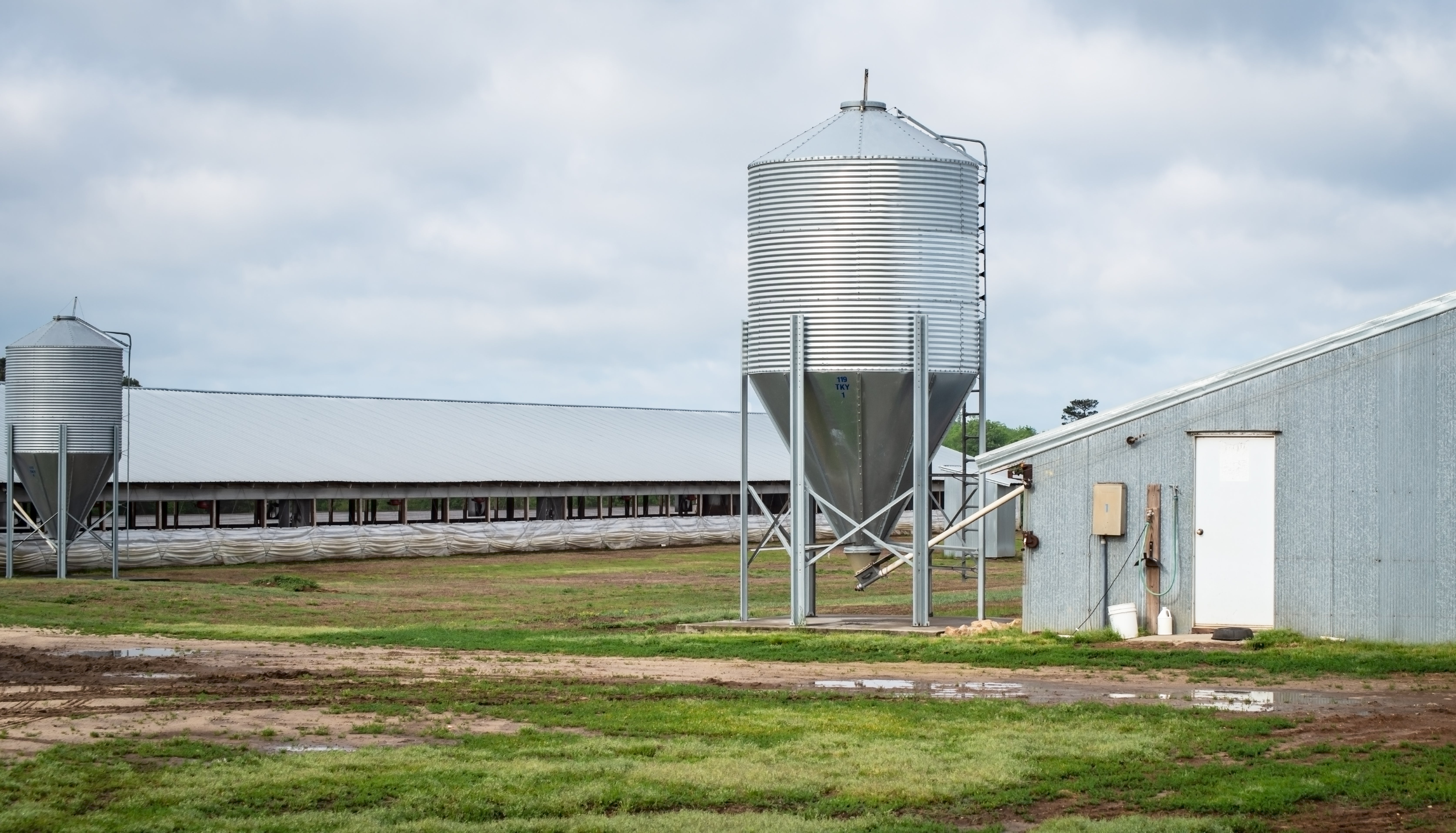 small grain hopper next to a shed