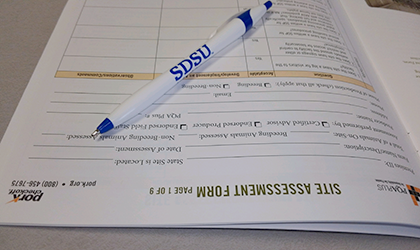 A site assesment form with a pen sitting on top.