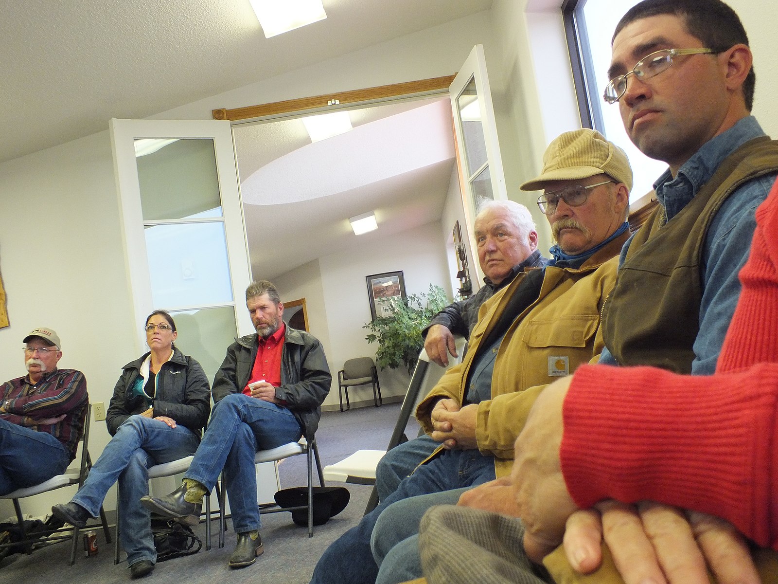 A group of farmers and ranchers sitting at a meeting