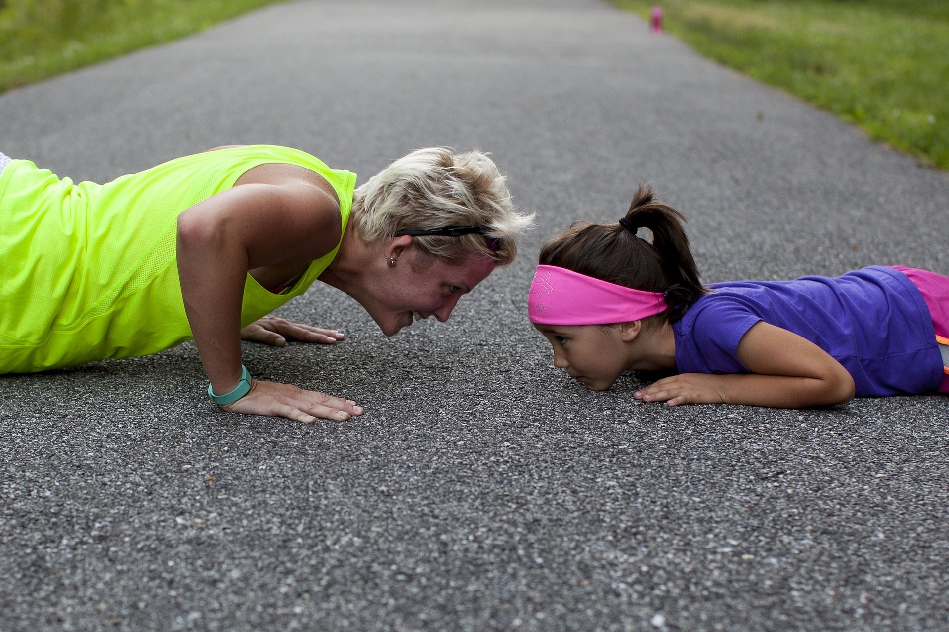 A mother and daughter doing pushups.
