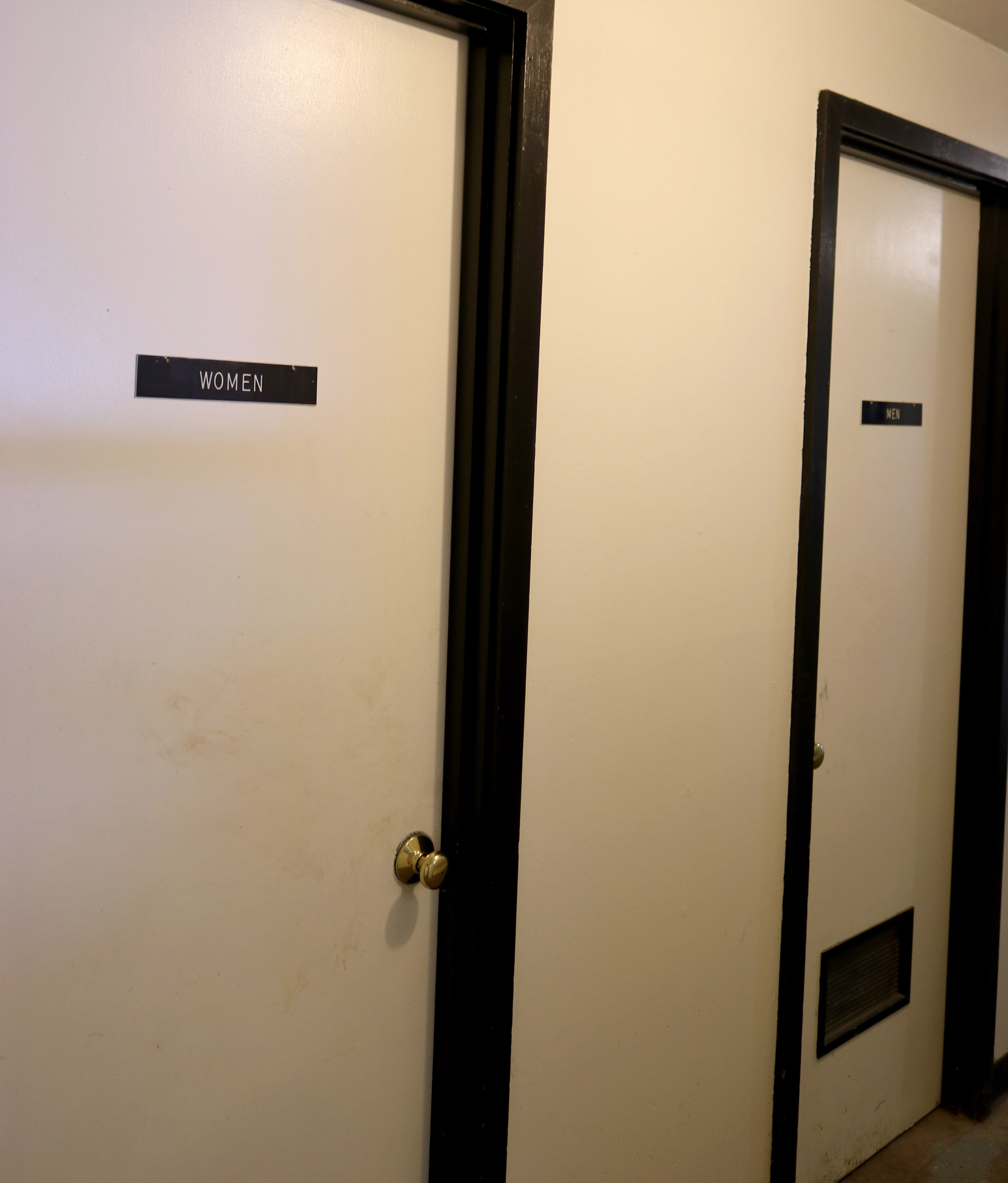 two restroom doors side by side. left is women's room. right is men's.