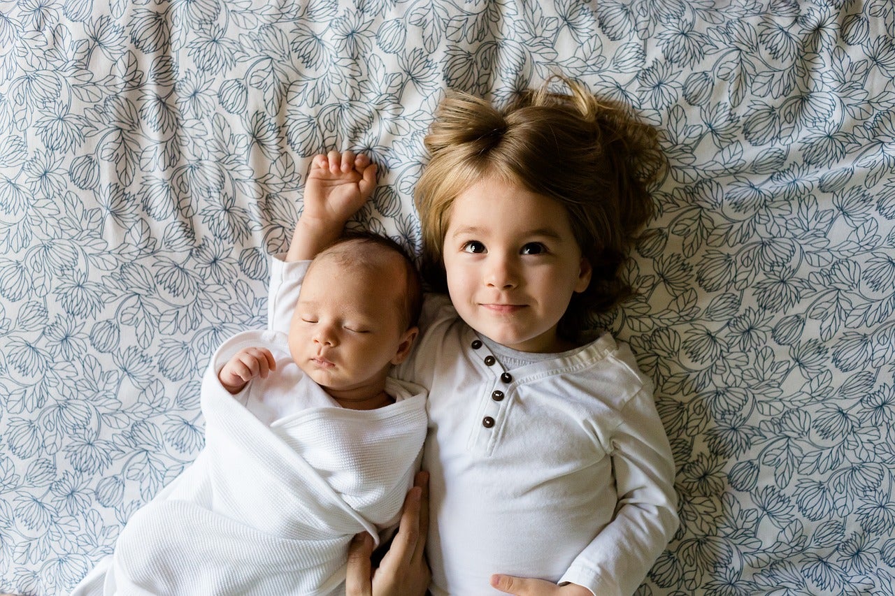 two children resting in bed