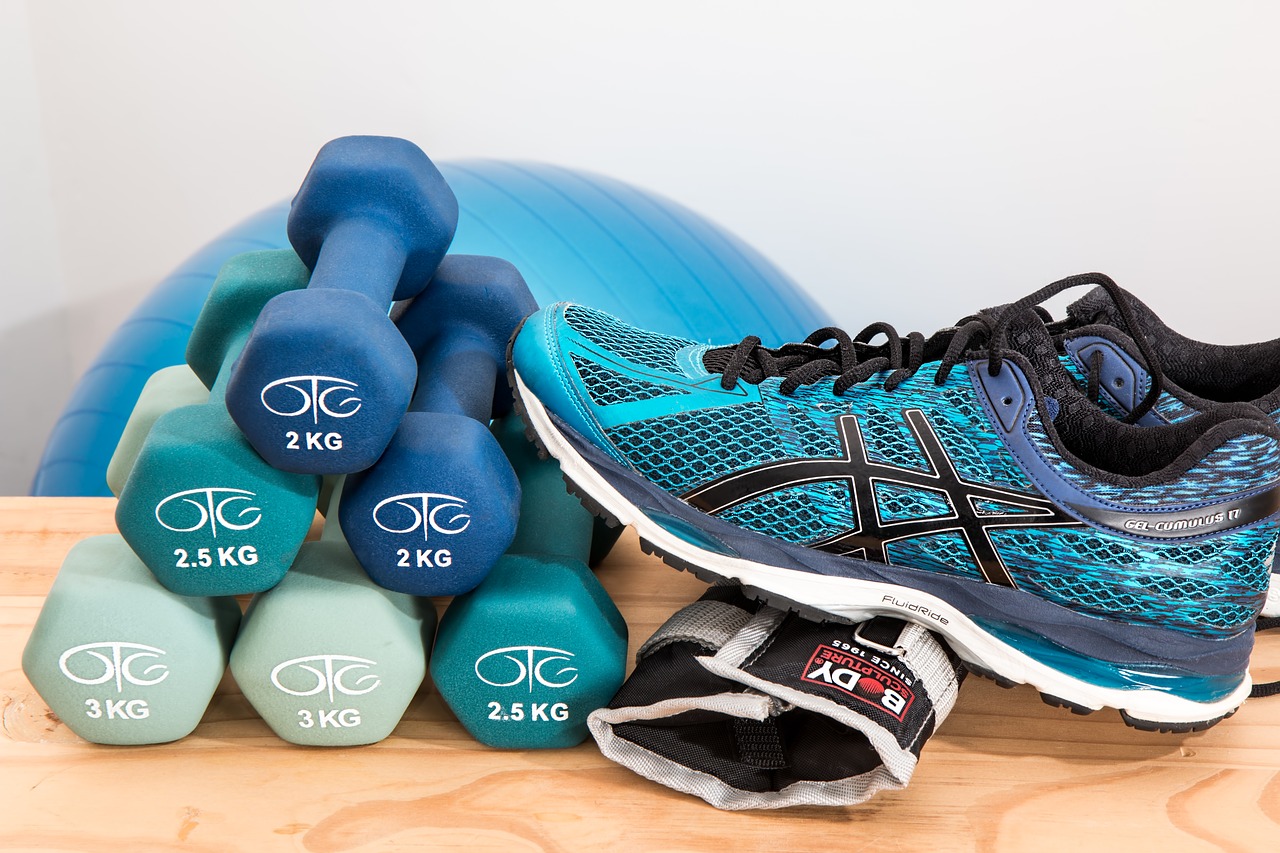 athletic shoe next to stack of small weights
