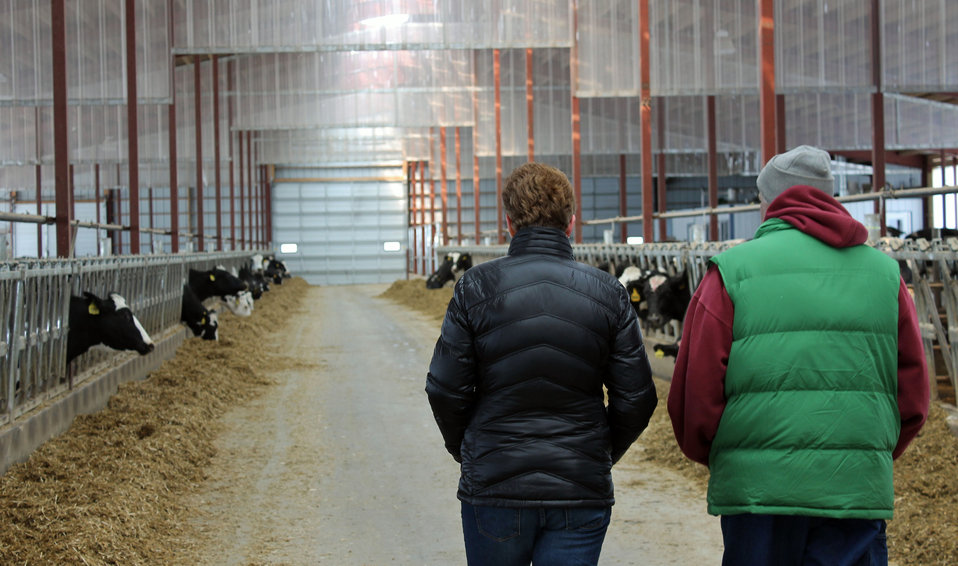 Two producers inspecting a dairy barn.