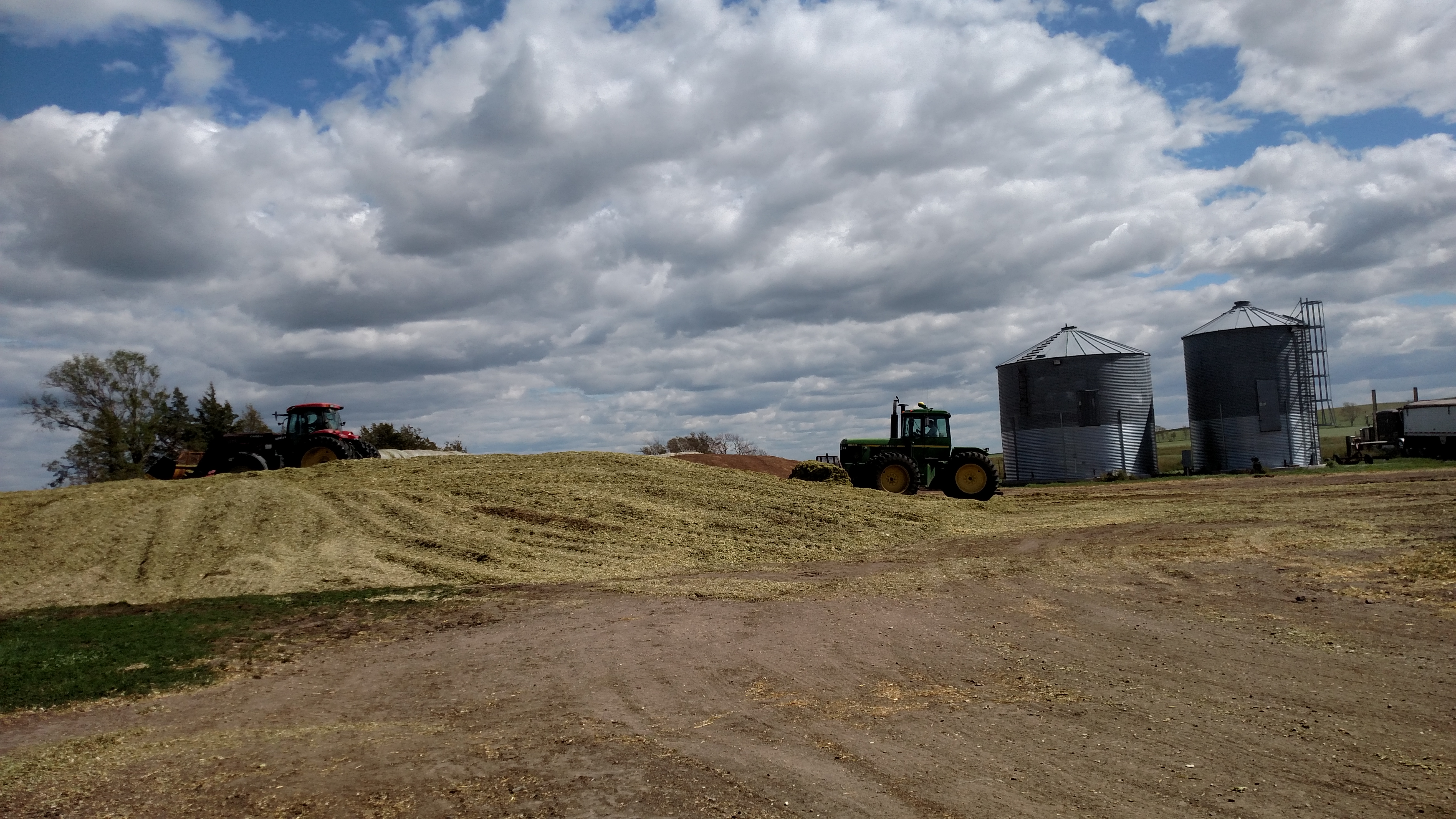 tractor near pile of harvested silage