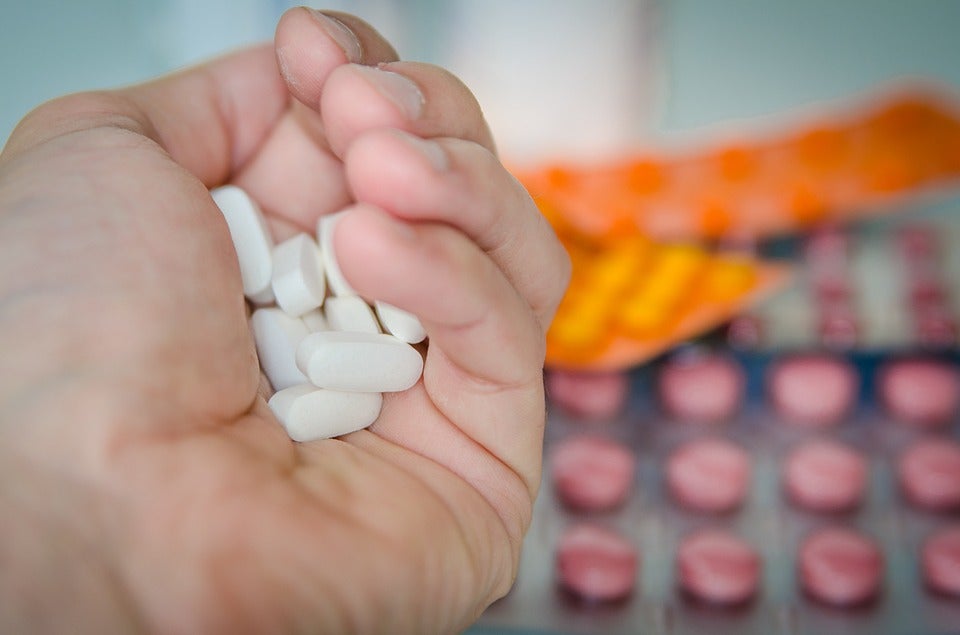 Hand holding pills.