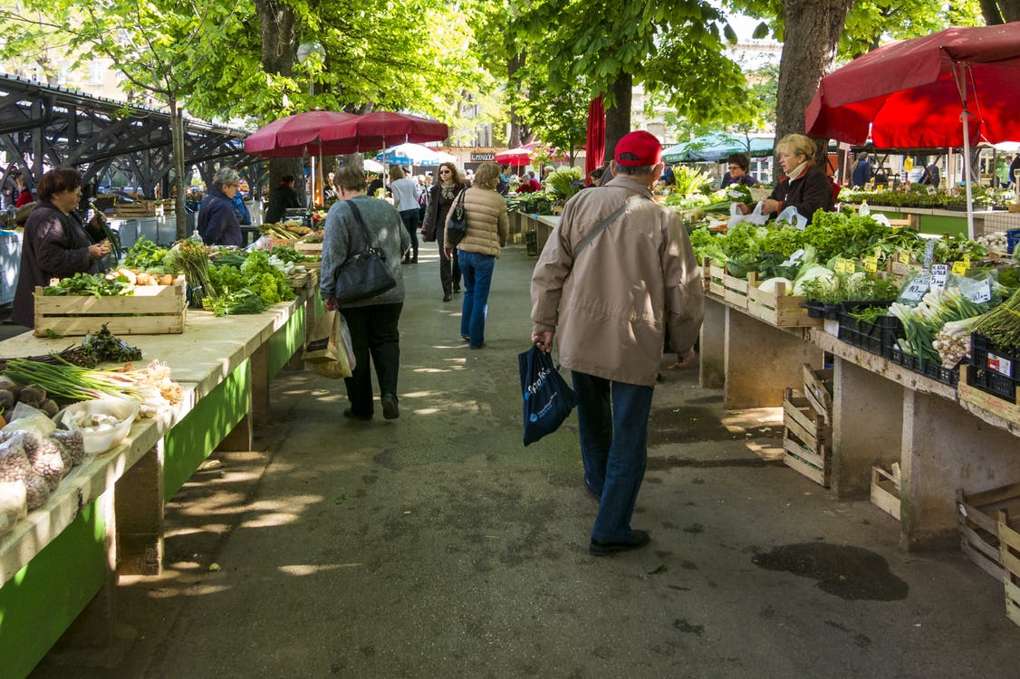 people shopping at a farmer's market