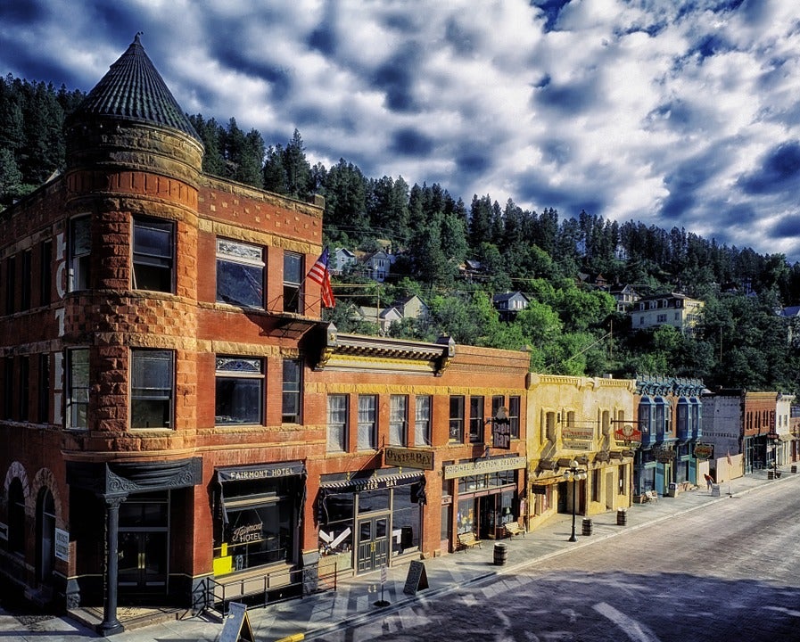 Downtown main street with storefronts and apartment buildings.