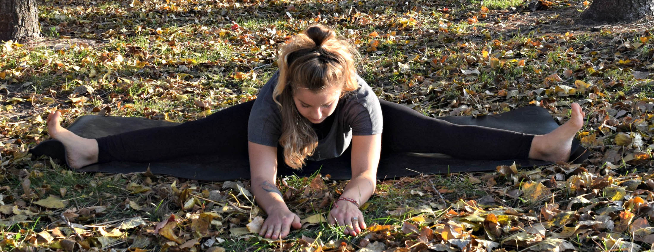 Young woman demonstrating wide-angle seated forward bend pose