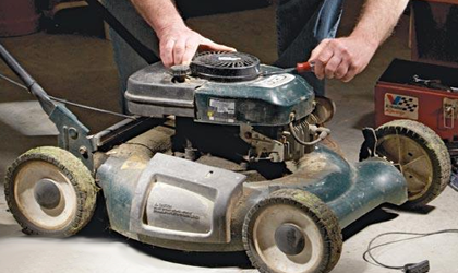 green lawnmower being tuned up