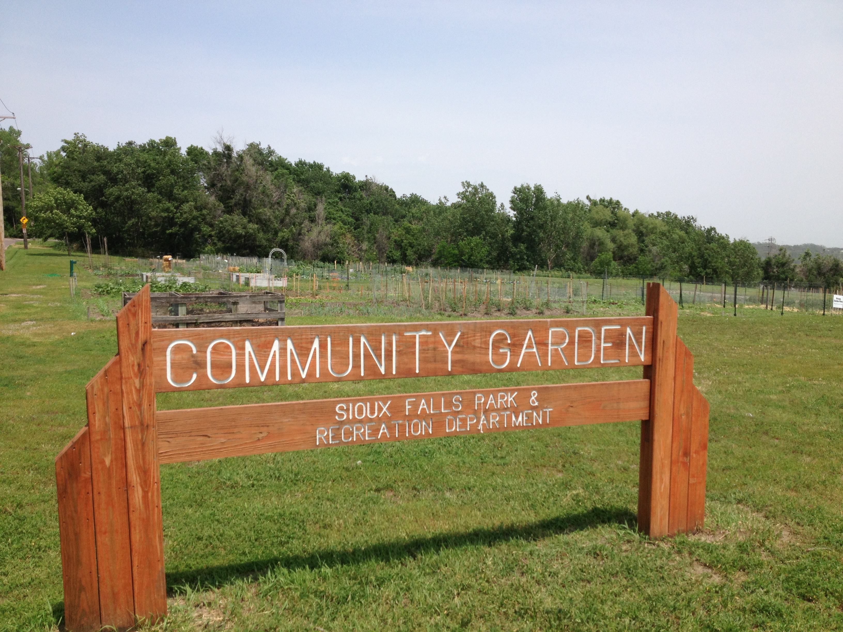 a wooden sign for a community garden
