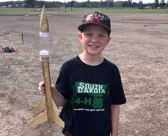 male 4-H youth holding a model rocket