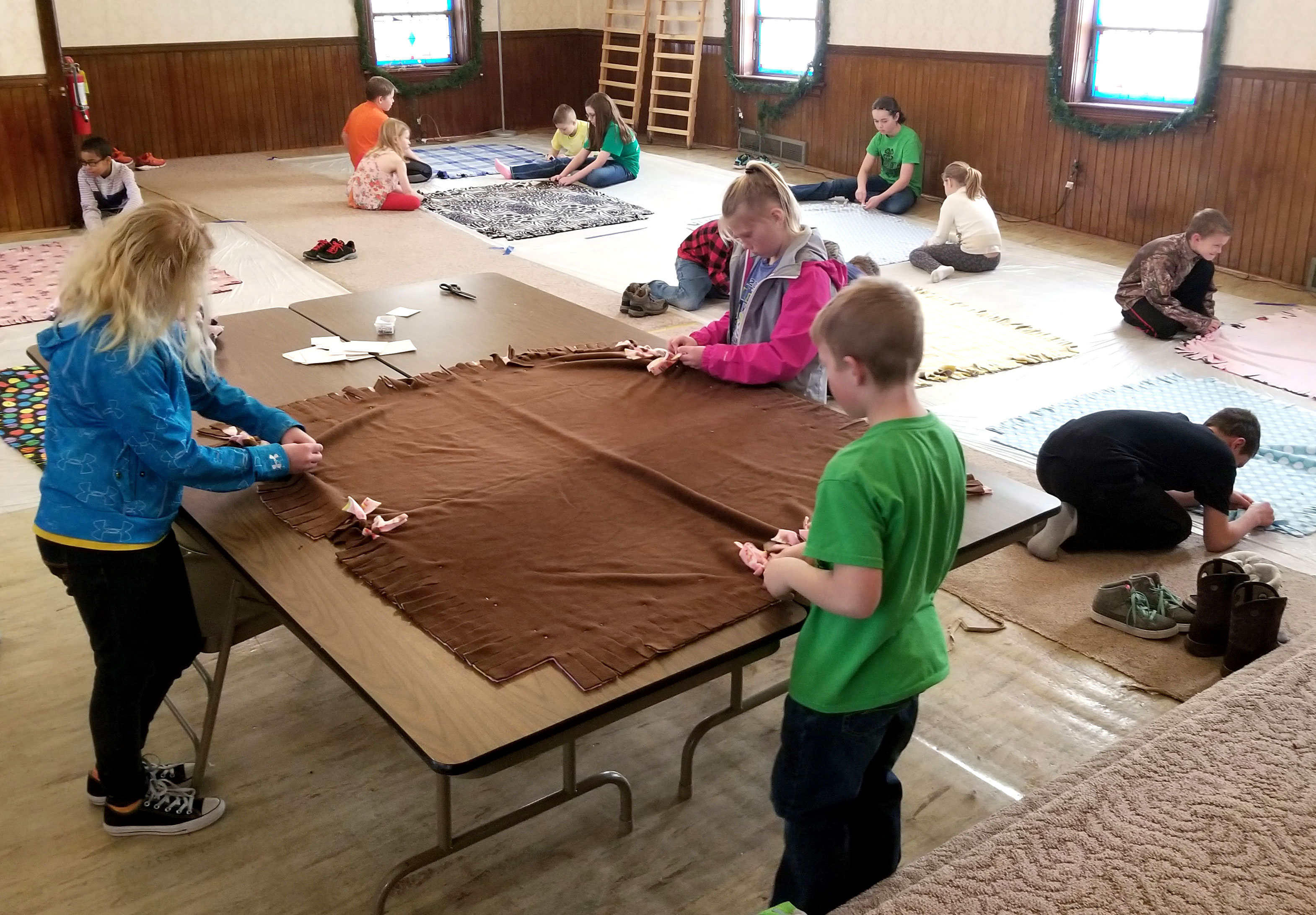 group of 4-H youth participating in a blanket-making workshop