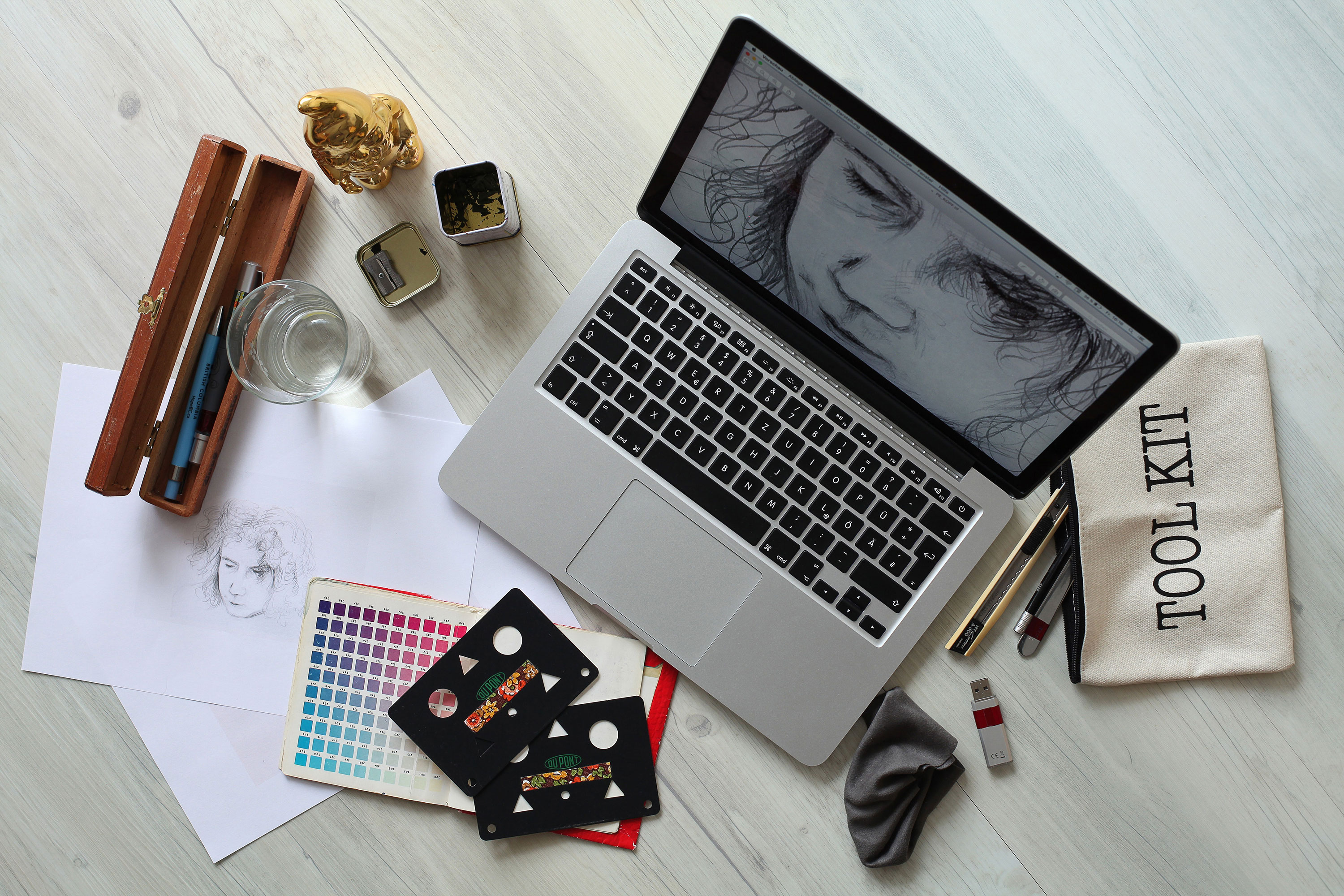 laptop computer and various design tools sitting on a desk