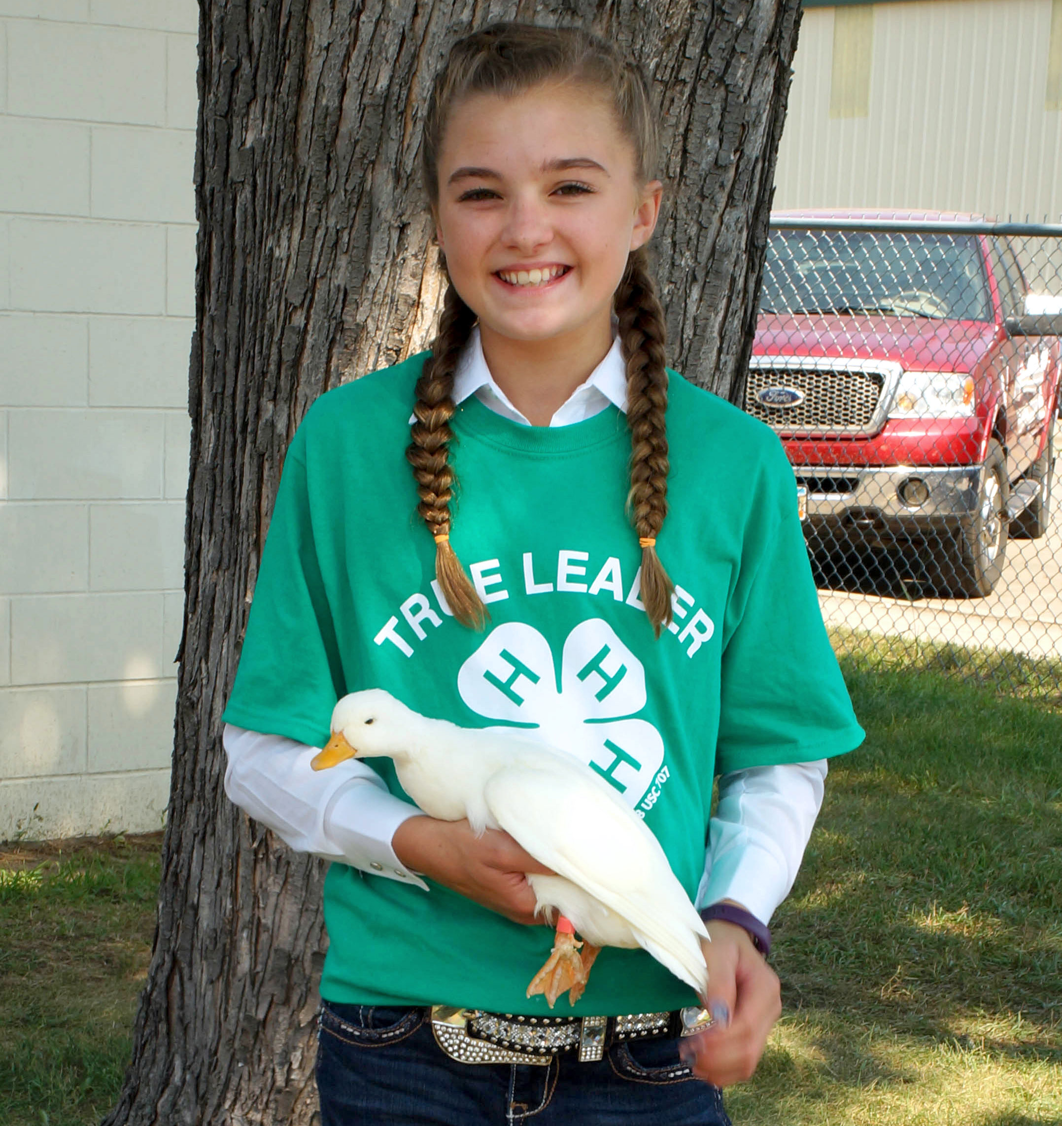 female 4-H youth holding a white duck