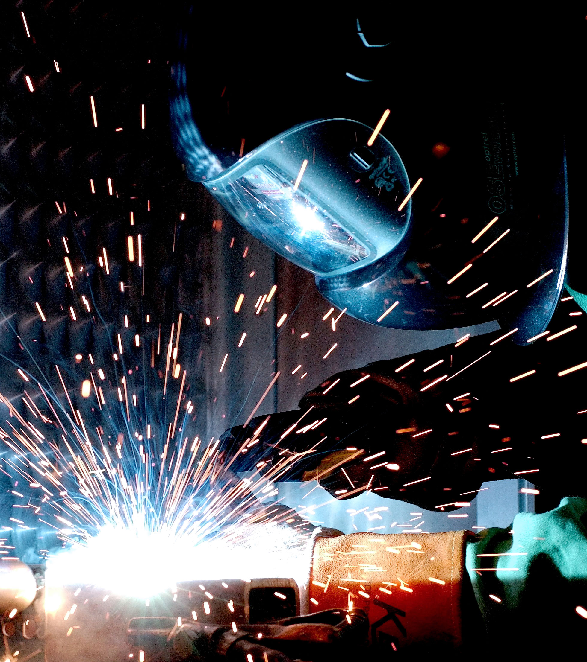 Man in welding mask welding metal pieces together