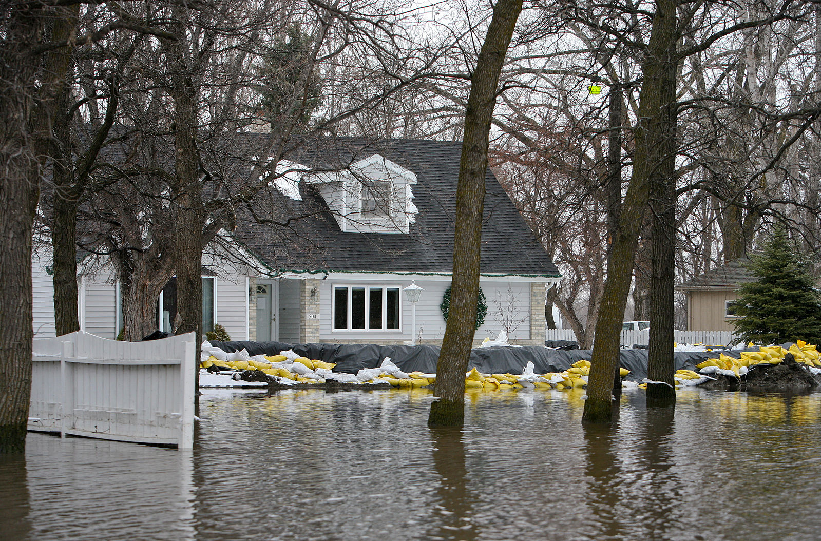 Sand Bagged home in surrounded by flood water. FEMA News Photo