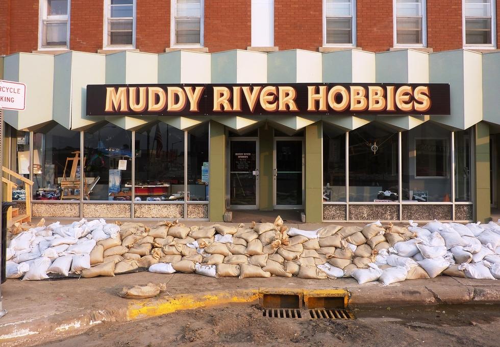 Small business "Muddy River Hobbies" with sandbags in front of entrance. Photo by Jeannie Mooney, FEMA.