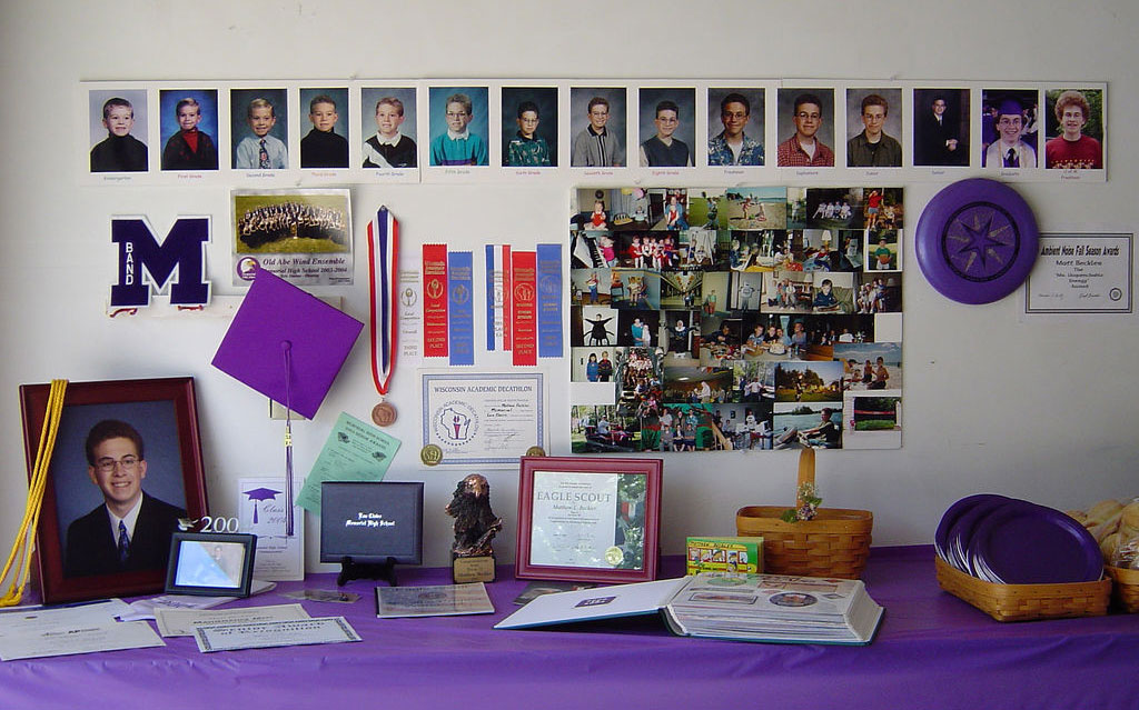 Graduation table display with photos, awards, and keepsakes. Courtesy: Matthew Beckler [CC BY-SA 2.0]