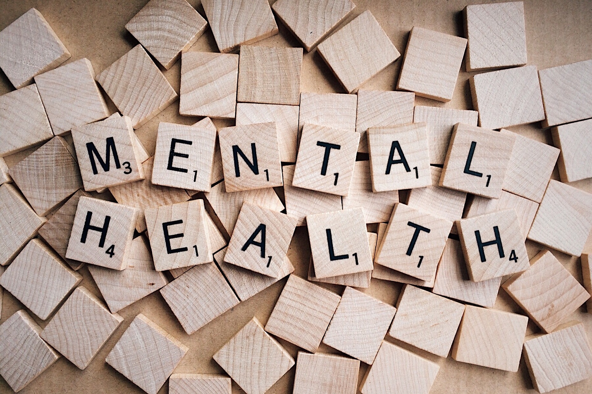 scrabble tiles arranged to spell mental health