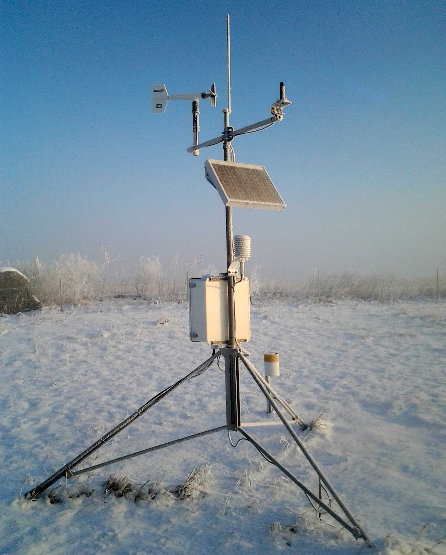 A South Dakota Mesonet station in a snow-covered field.