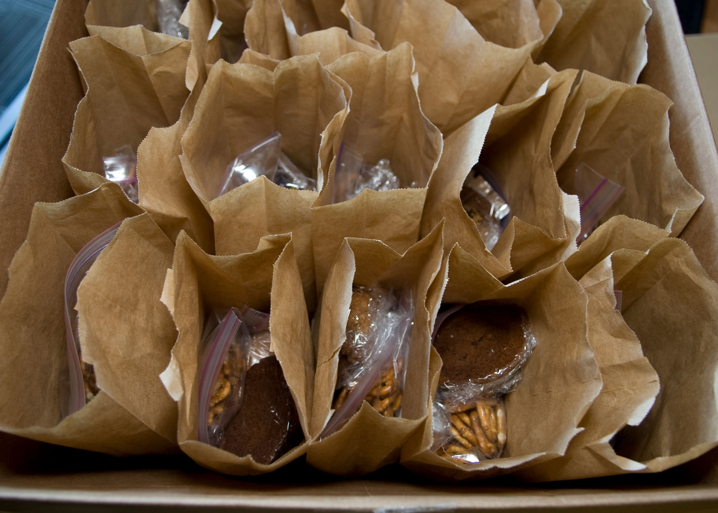 A box filled with sack lunches available for children to take home.