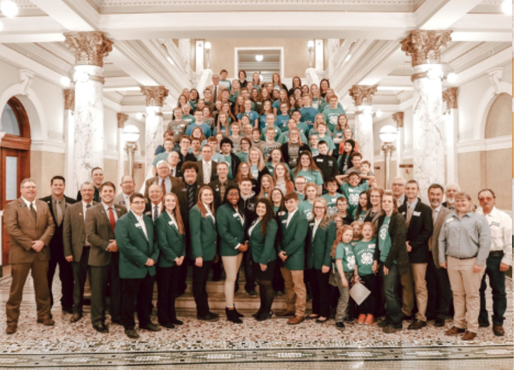 a large group of 4-H members and supporters standing on the Capitol stairs