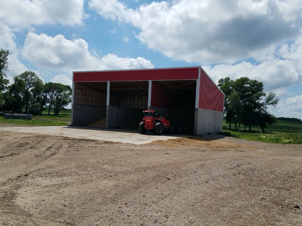 a red shed with grain stored inside