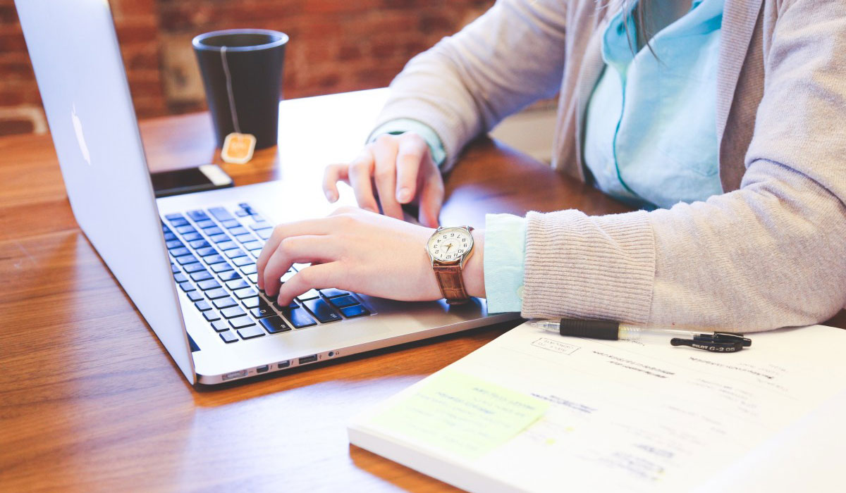 A young woman browsing personal finance resources on a laptop computer.