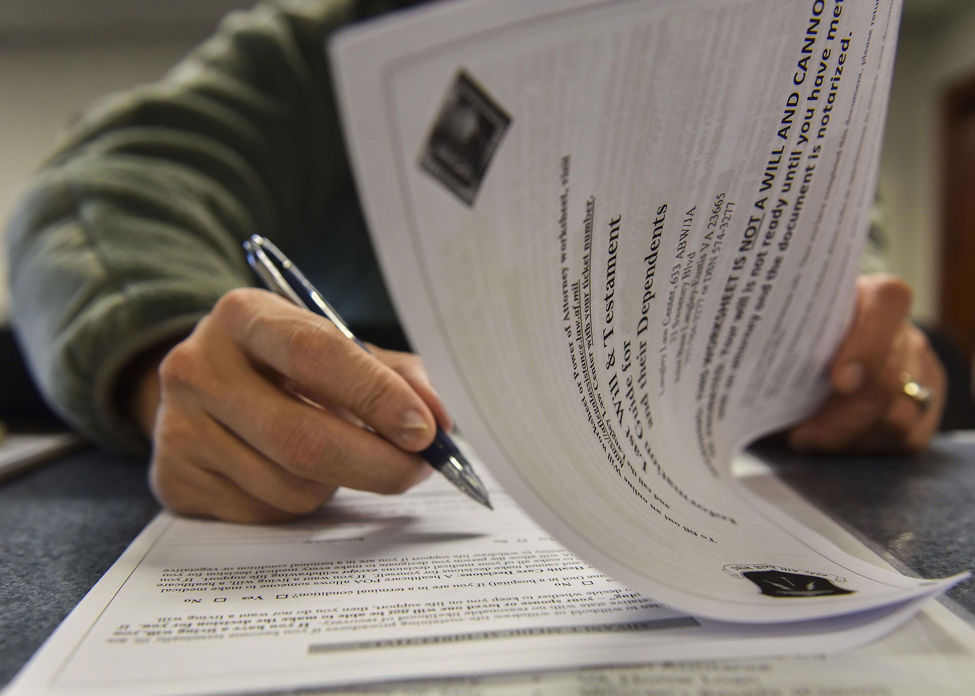 A man reviewing an information packet on creating a last will and testament.