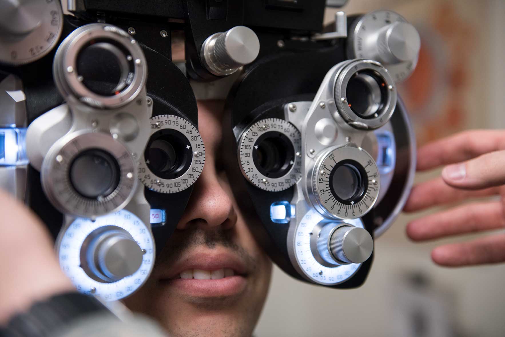 A young man receiving an optometry examination.