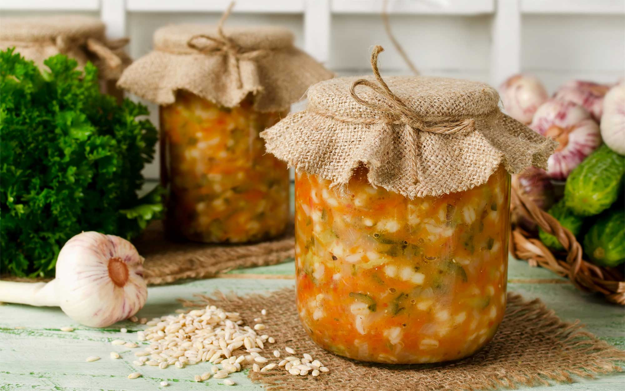 Jars of home-canned soup on a countertop.