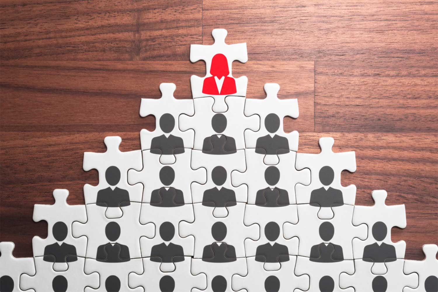 A pyramid-shaped puzzle representing the structure of a business hierarchy.