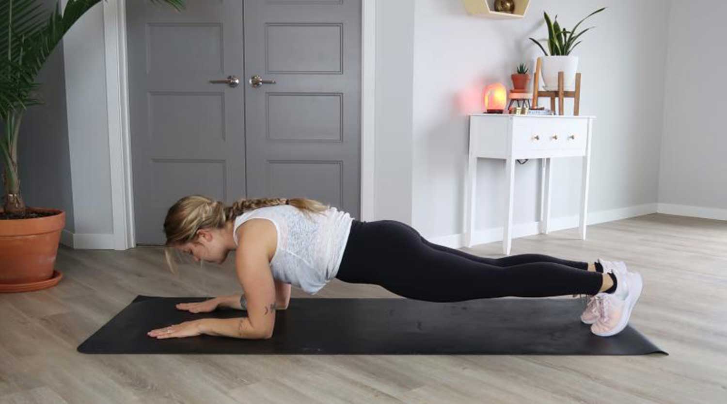 Young woman demonstrating forearm plank exercise movements. For a complete description, call SDSU Extension at 605-688-6729.
