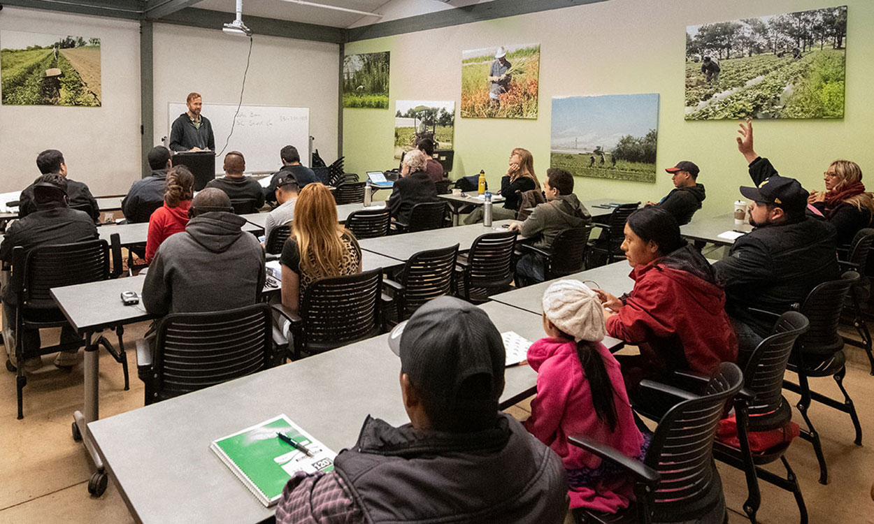 Group of young producers viewing a presentation in a classroom.