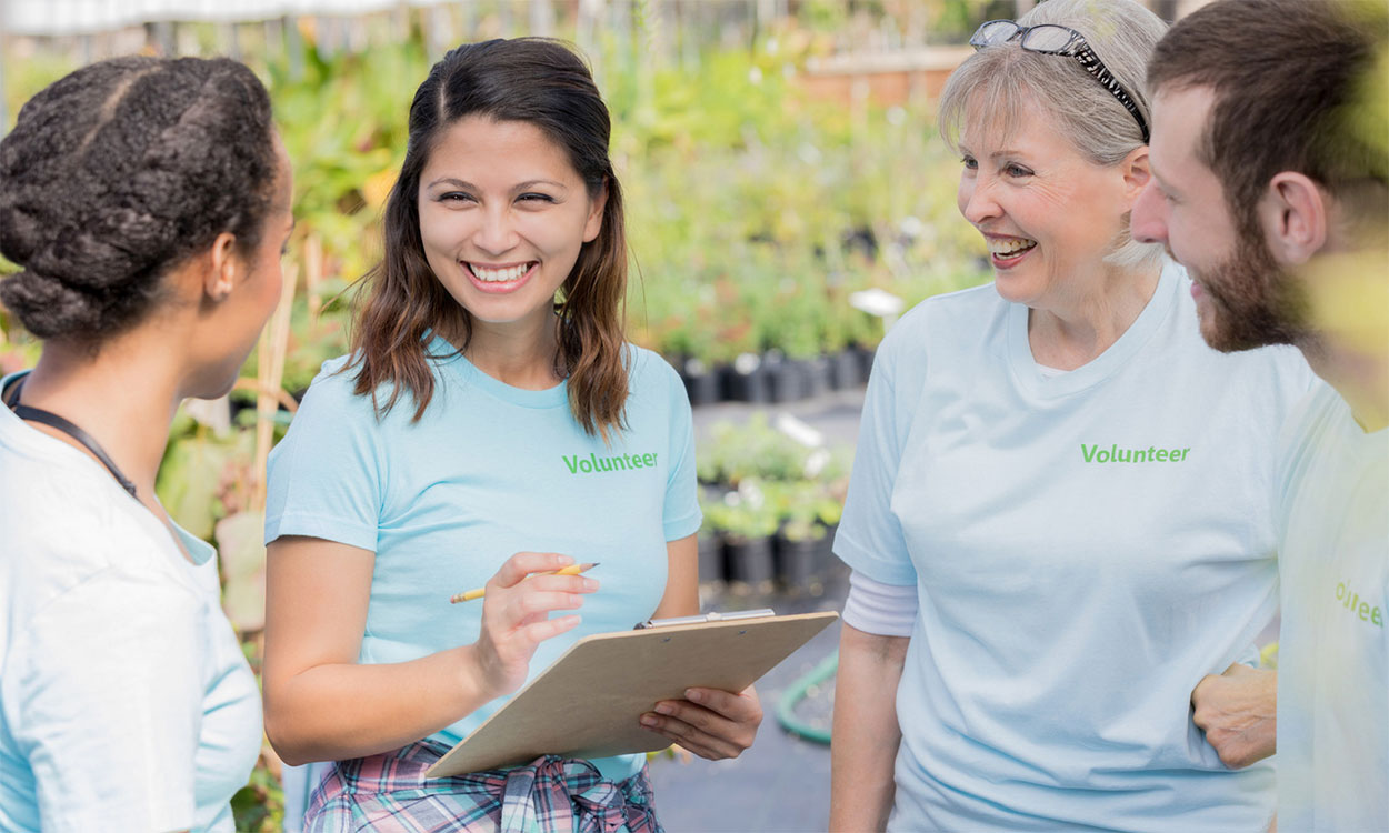 Group of volunteers working in a garden center.