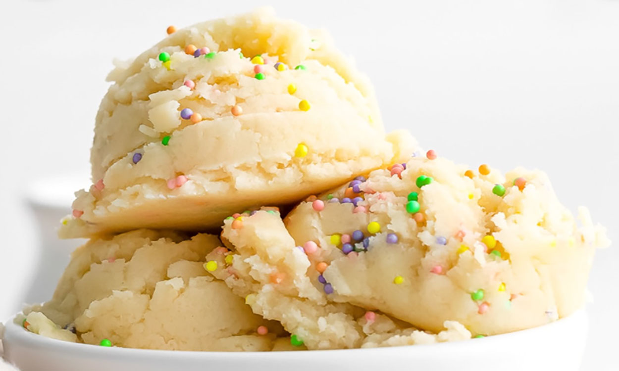 Scoops of ready-to-eat cookie dough in a white bowl.