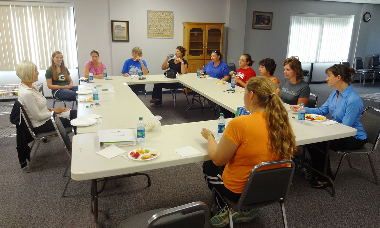 Community wellness coalition meeting in a board room.