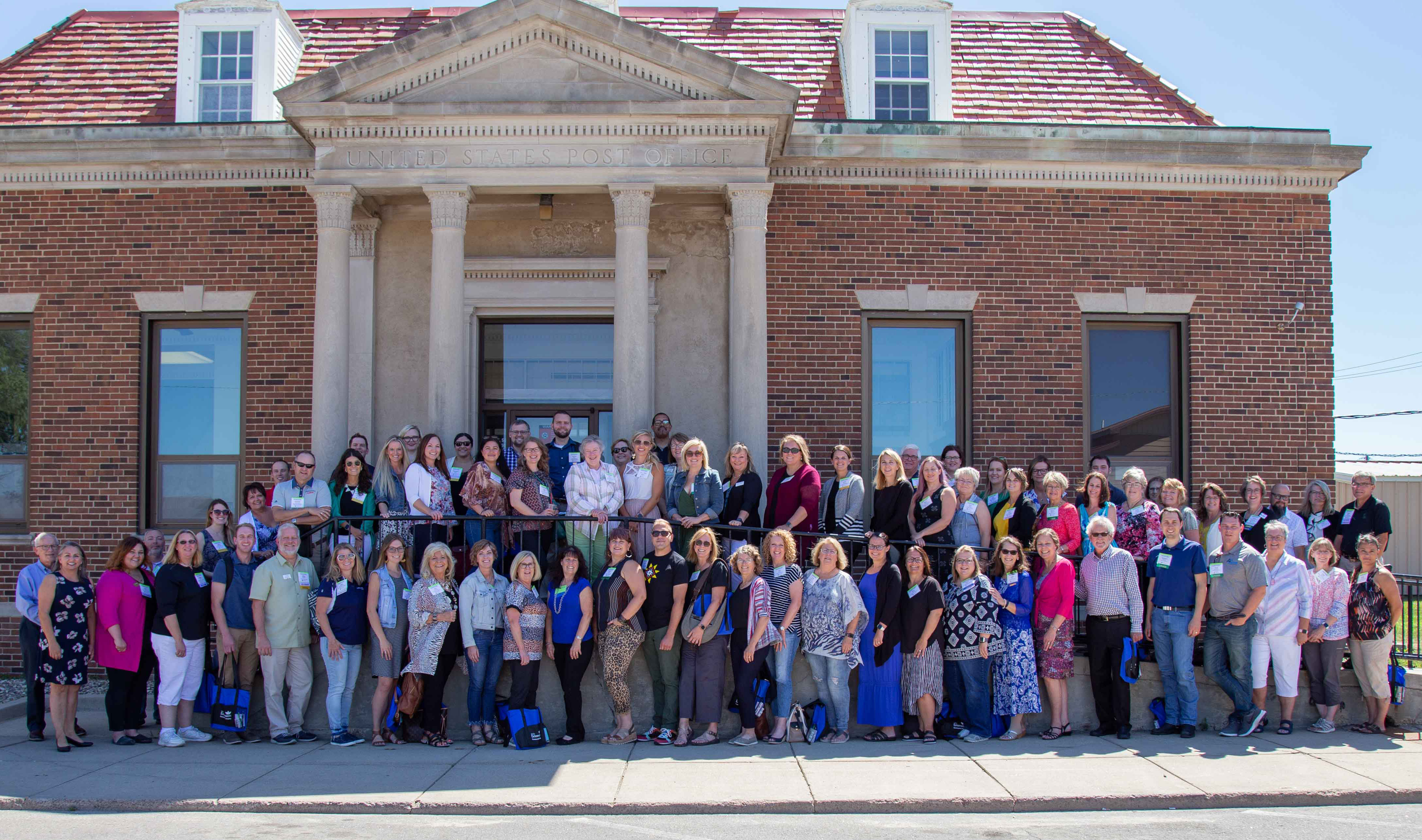 2021 Energize! Conference attendees gathered outside a brick building.