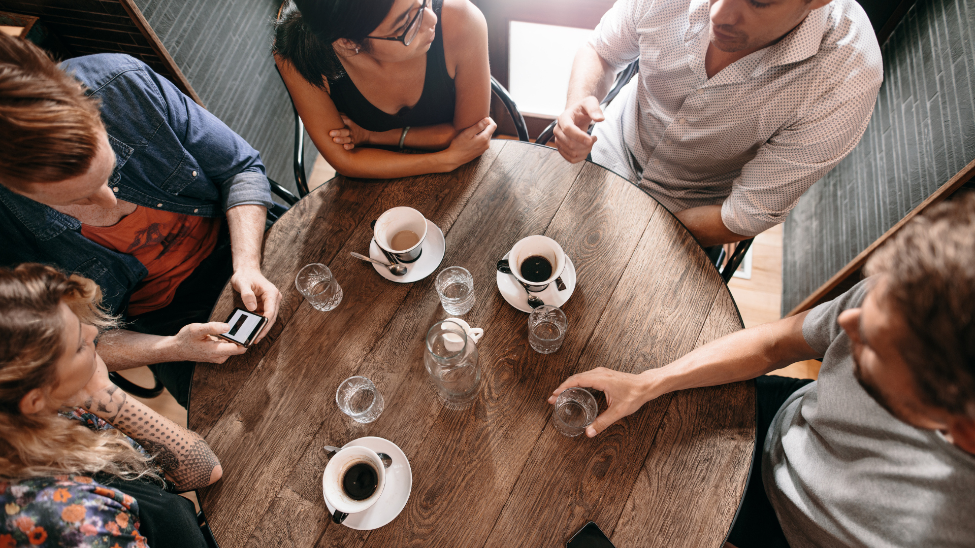 Group of people having discussion over coffee