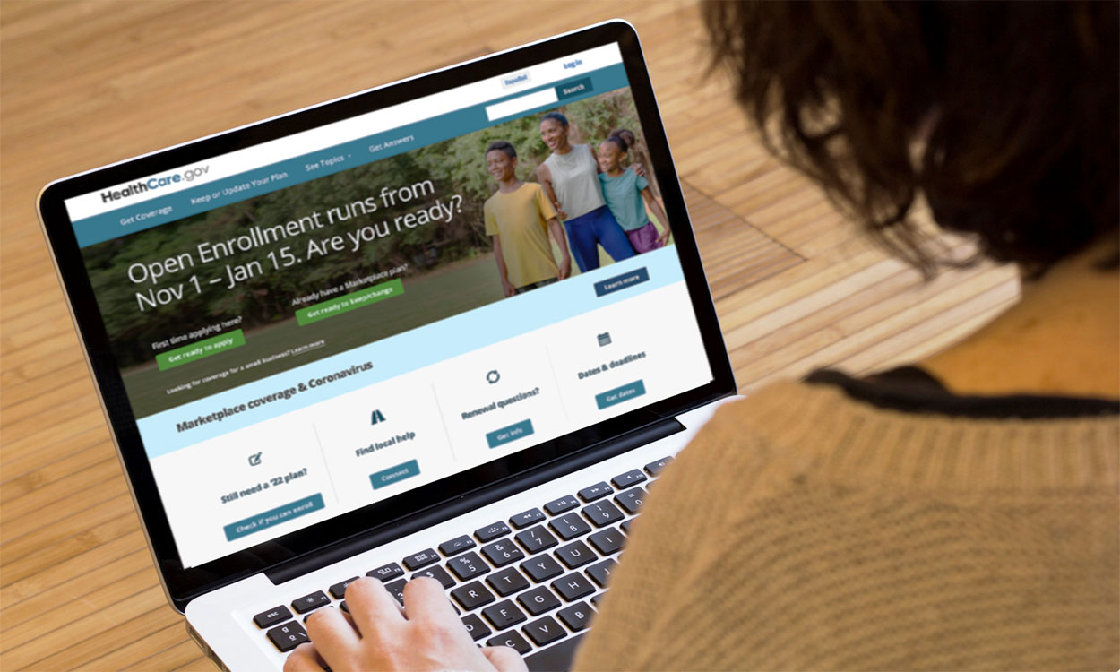 Woman navigating Health Insurance Marketplace on laptop.