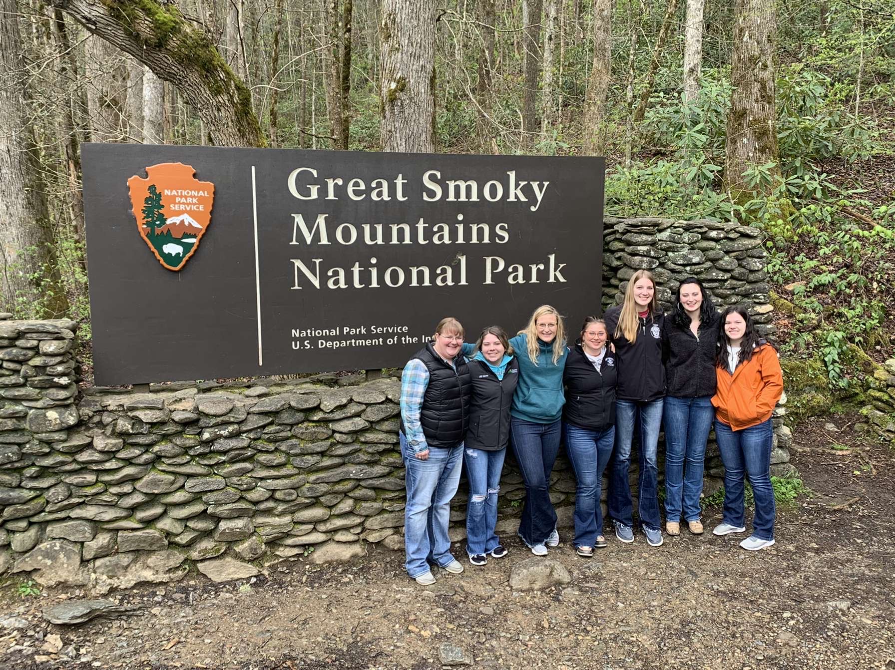 Group of Collegiate 4-H members standing in front of Great Smoky Mountains National Park sign