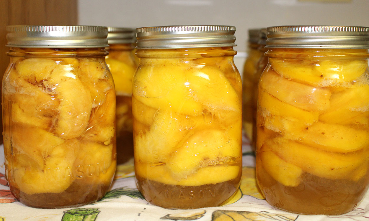 Jars of home-canned peaches.