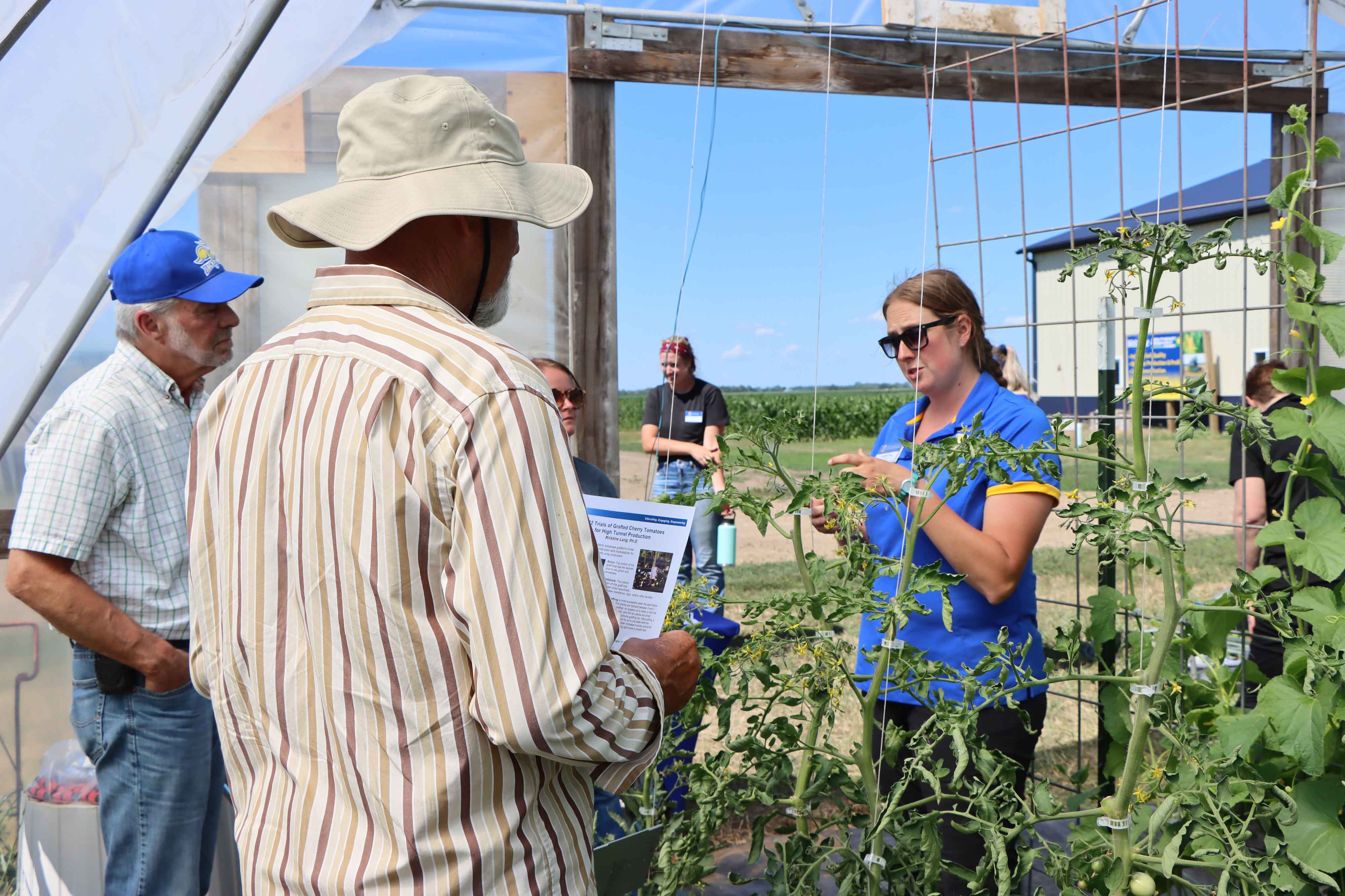 An Extension specialist speaks to two attendees at the 2022 Research Farm Field Day