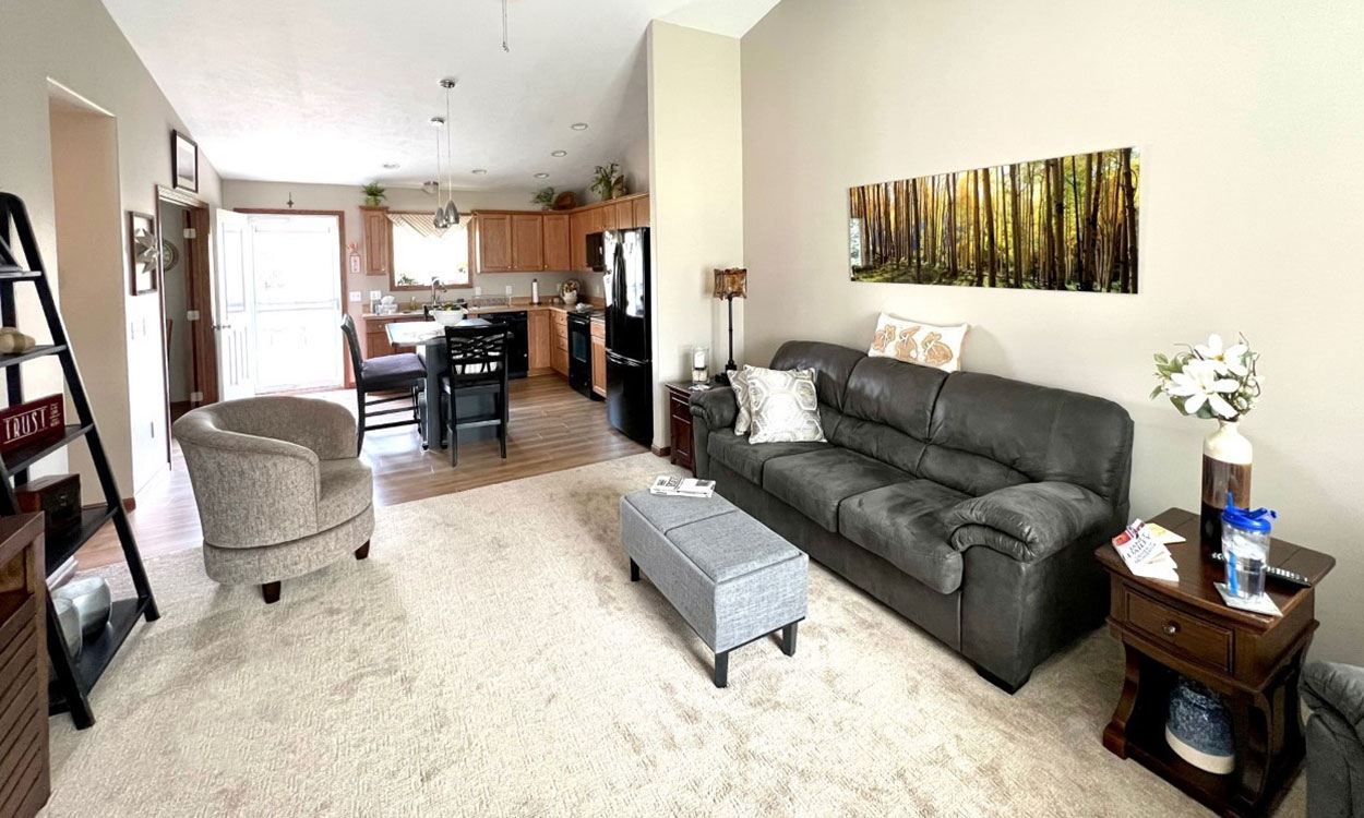 Open kitchen and living room area with ample wheelchair clearance throughout.