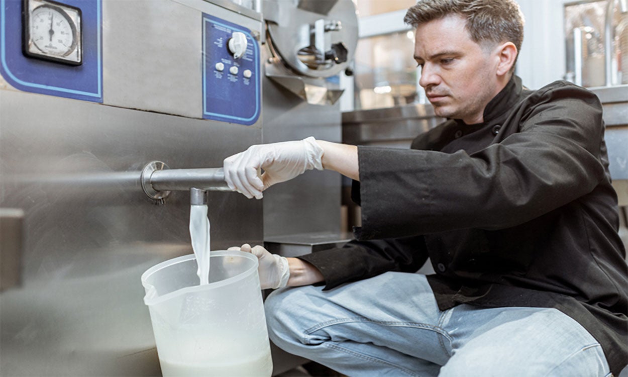Producer dispensing pasteurized milk from a pasturizer.