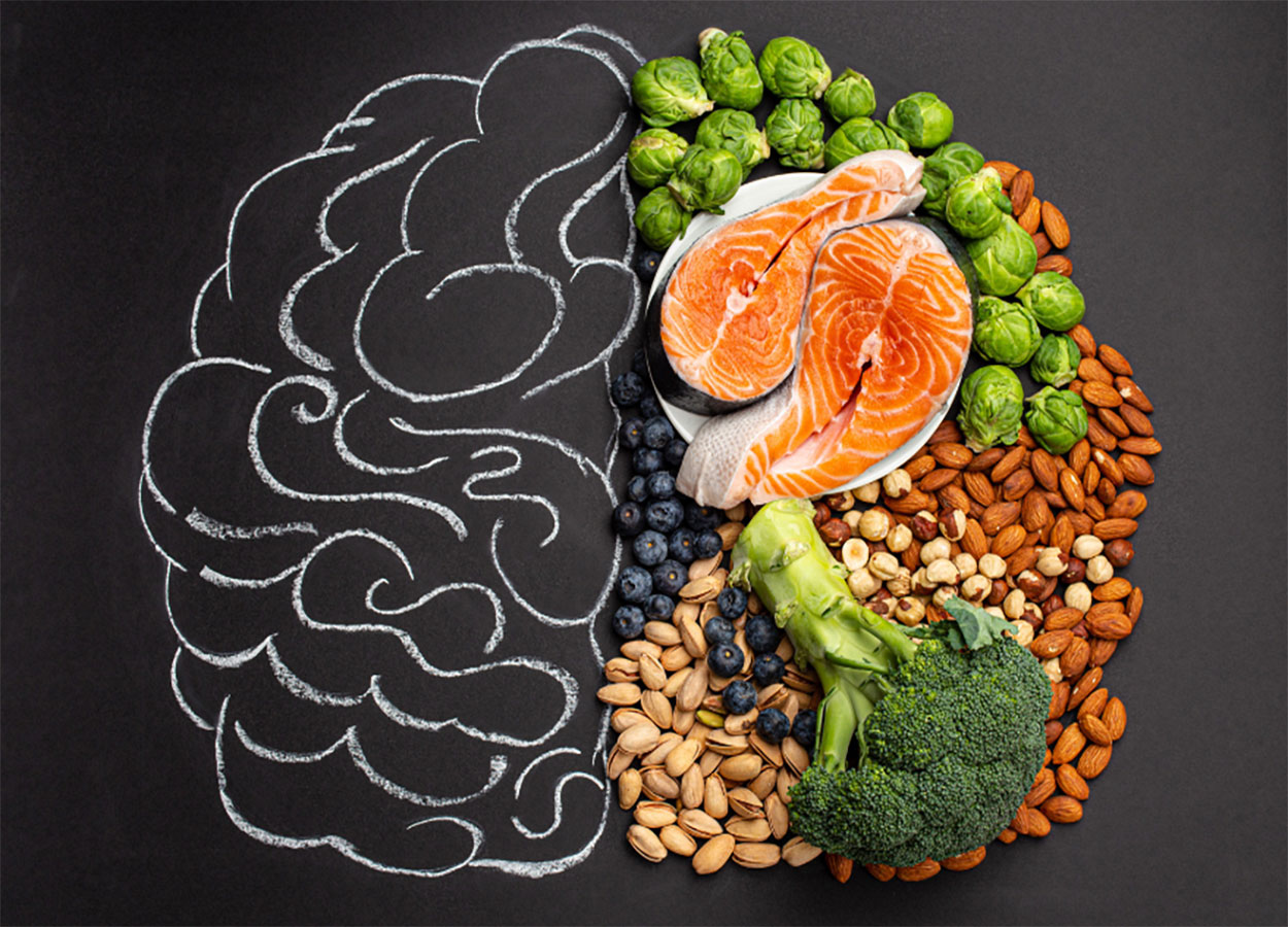 Variety of healthy foods laying over a chalk illustration of a human brain.