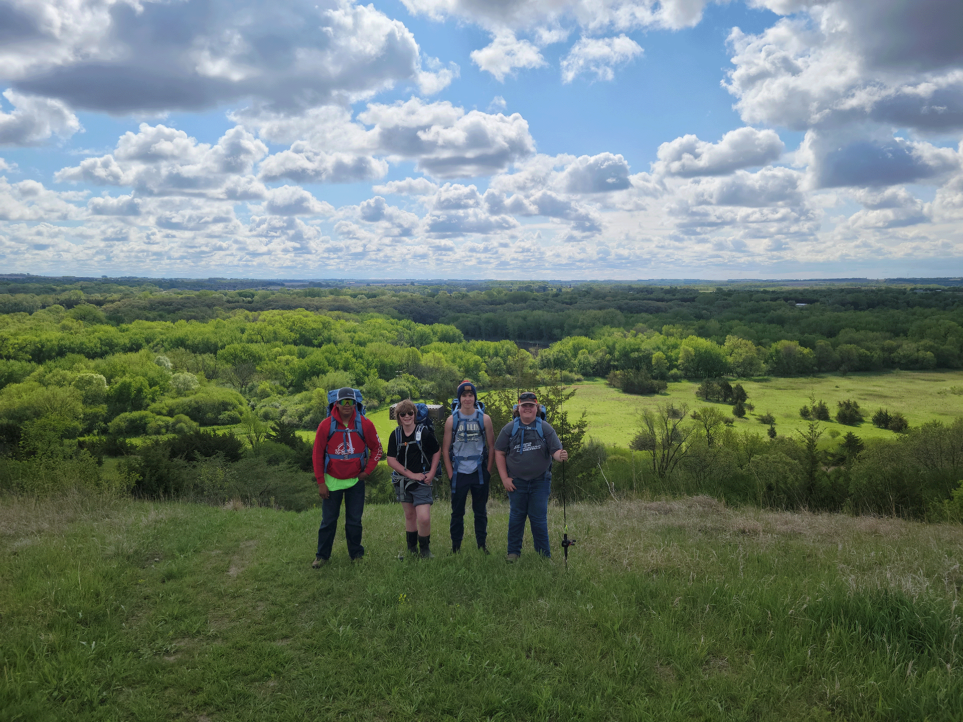 Group of youth standing atop a hill